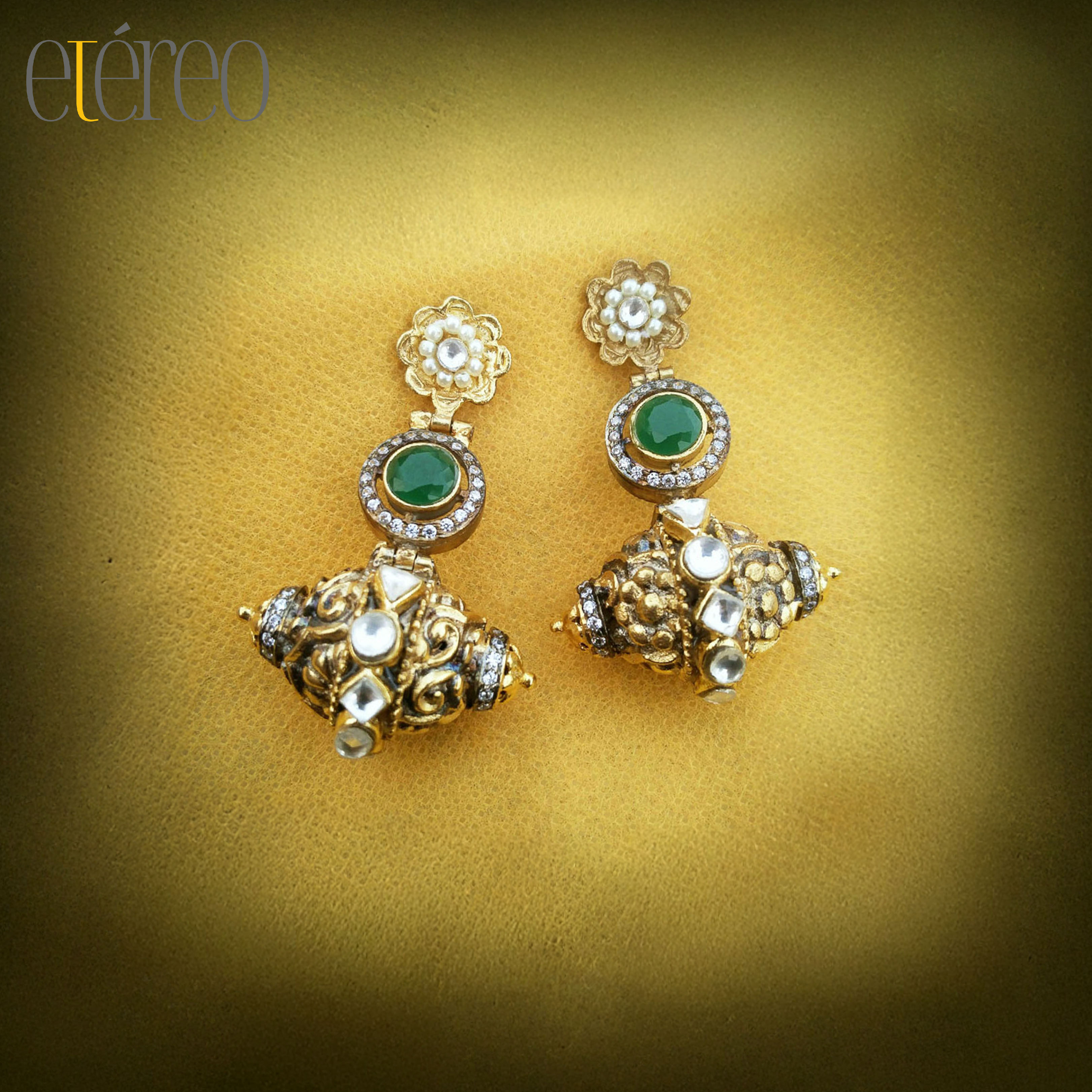 ER2023-Carved damru in gold with green stone n zircons